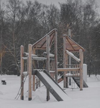 a playground in the snow with a slide