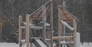 a playground in the snow with a slide
